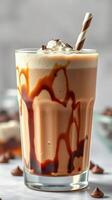Delicious creamy chocolate drink with whipped cream and chocolate drizzle served in a tall glass photo