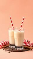 Creamy milkshakes with striped straws and candy canes on a playful backdrop in a cozy setting photo