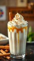 Creamy dessert drink with caramel sauce and cinnamon garnishes served in a glass at a cozy cafe photo