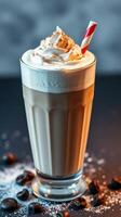 Delicious coffee drink topped with whipped cream and a straw in a stylish glass photo
