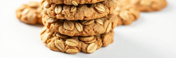 Delicious oatmeal cookies stacked high on a white surface, perfect for an afternoon treat or dessert photo