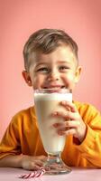 Young boy enjoys a delicious milkshake in a vibrant setting with a playful expression on his face photo