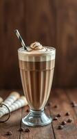 Delicious chocolate milkshake served in a tall glass with whipped cream and a straw on wooden table photo