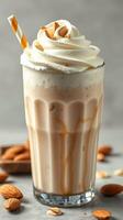 Creamy almond milkshake topped with whipped cream and almonds served in a tall glass photo