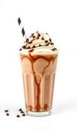 Rich chocolate milkshake topped with whipped cream and chocolate chips served in a clear glass with a striped straw photo