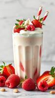 Creamy strawberry and raspberry milkshake served in a tall glass with fresh berries and whipped cream photo