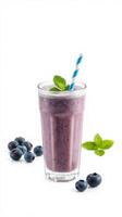 Refreshing berry smoothie served in a tall glass with mint leaves against a plain background photo