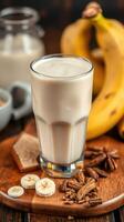 Creamy banana smoothie with spices and fresh ingredients on a wooden table photo
