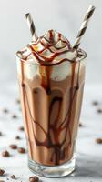 Delicious chocolate milkshake topped with whipped cream and chocolate drizzle, served in a tall glass photo