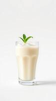 Creamy beverage with fresh mint garnish in a clear glass on a light background photo