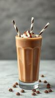 Creamy chocolate milkshake topped with whipped cream and chocolate drizzle in a tall glass photo