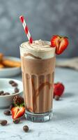 Creamy chocolate strawberry milkshake served in a tall glass with whipped cream and fresh strawberries photo