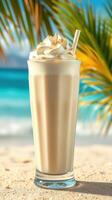 Creamy tropical dessert drink served with whipped topping on a sunny beach photo