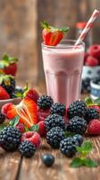 Refreshing berry smoothie prepared with fresh strawberries, raspberries, and blackberries on a wooden table photo