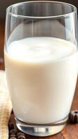 Refreshing glass of milk served on a wooden table with decorative coffee beans and a cloth napkin photo