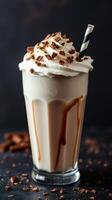 Creamy chocolate milkshake topped with whipped cream and chocolate shavings served in a tall glass photo