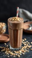Delicious chocolate smoothie topped with oats and served with crunchy toppings in a stylish glass photo