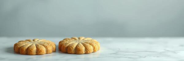 Cookies with intricate designs placed on a marble countertop in a bright kitchen setting photo