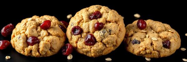 Homemade cookies with cranberries and oats arranged beautifully on a black background photo