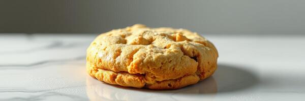 Soft and fluffy homemade cookie placed on a marble surface in natural light photo