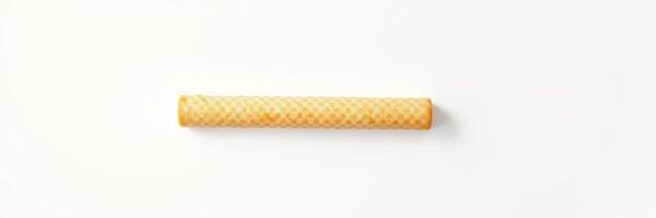 Sweet rolled wafer with a textured surface placed against a plain background photo