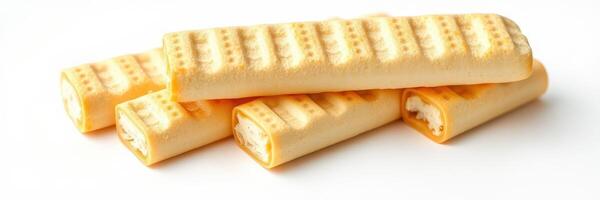 Assorted cream-filled wafers stacked on a plain surface in natural light highlighting their texture photo
