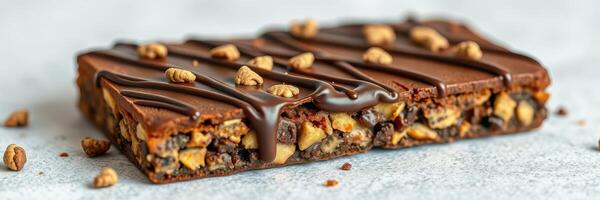 Chocolate protein bar with crunchy peanut topping on a light surface photo