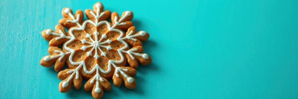 Beautifully decorated gingerbread snowflake on a vibrant teal background showcasing festive spirit in winter photo