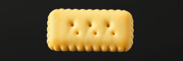 Unique yellow biscuit on black background creates visual appeal in minimalistic food photography photo