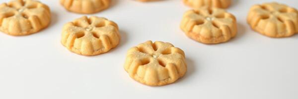 Delicious homemade cookies shaped like flowers arranged on a white background ready to be served photo