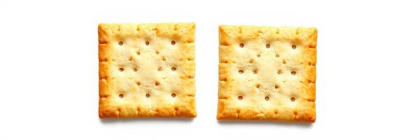 Square crackers arranged side by side on a white background showcasing their golden texture and perforations photo