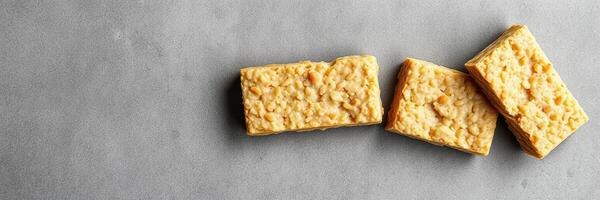 Delicious oat-based snack bars arranged on a gray background with a focus on texture and shape photo