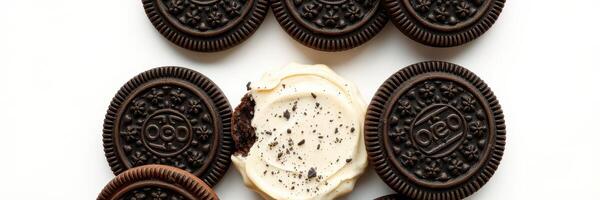 Delicious assortment of chocolate cookies with cream filling displayed on a white background photo