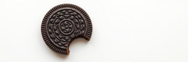 Broken chocolate cookie with intricate design on a light background photo