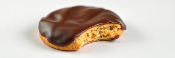 Chocolate covered cookie with a bite taken out, revealing a soft filling, perfect for dessert lovers photo