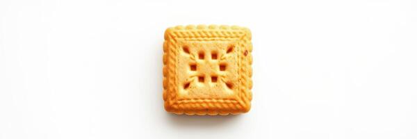 Crispy golden square biscuit with intricate pattern on a white background photo