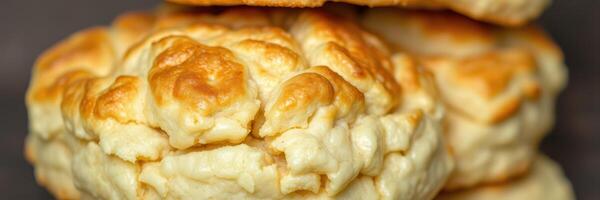 Freshly baked biscuits stacked on a dark surface ready to be served with butter or jam photo