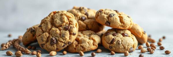 Freshly baked chocolate chip cookies on a textured surface with scattered ingredients for a warm and inviting treat photo