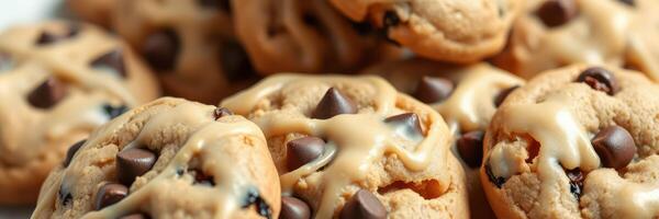 Chocolate chip cookies baked to perfection, showcasing a delightful arrangement and a drizzle of creamy icing photo