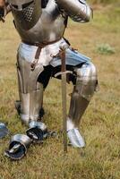 Close-up of a medieval knight in armor preparing for battle photo