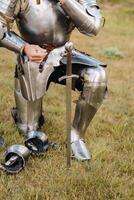 Close-up of a medieval knight in armor preparing for battle photo