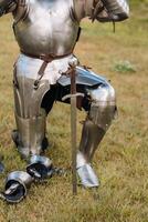 Close-up of a medieval knight in armor preparing for battle photo