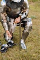 Close-up of a medieval knight in armor preparing for battle photo