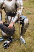 Close-up of a medieval knight in armor preparing for battle photo