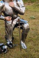 Close-up of a medieval knight in armor preparing for battle photo