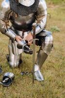 Close-up of a medieval knight in armor preparing for battle photo