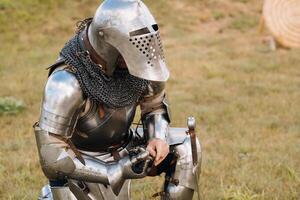 Close-up of a medieval knight in armor preparing for battle photo
