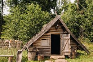 Triangular log houses with wooden roofs behind a fence. Montenegro, north photo
