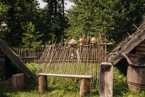 wooden bench in the courtyard in the village on a summer day photo