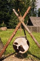 An old traditional drum with fur hanging in a medieval village photo